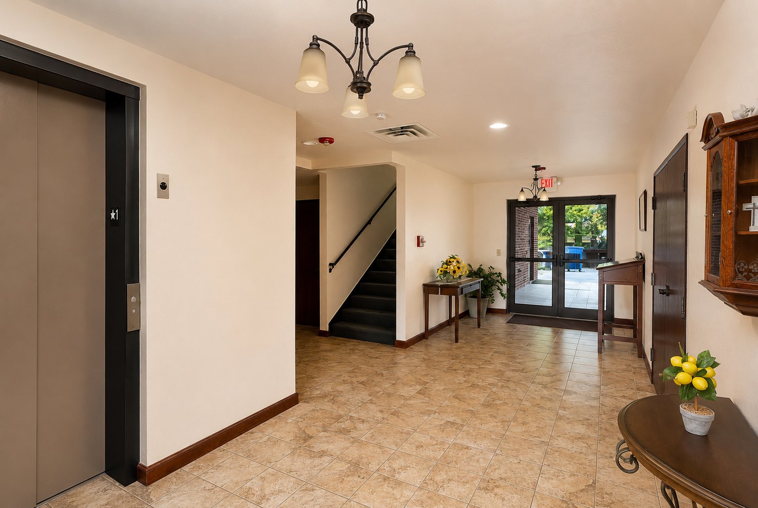 Entryway leading to the fellowship hall, with elevator, stairs, and glass front doors