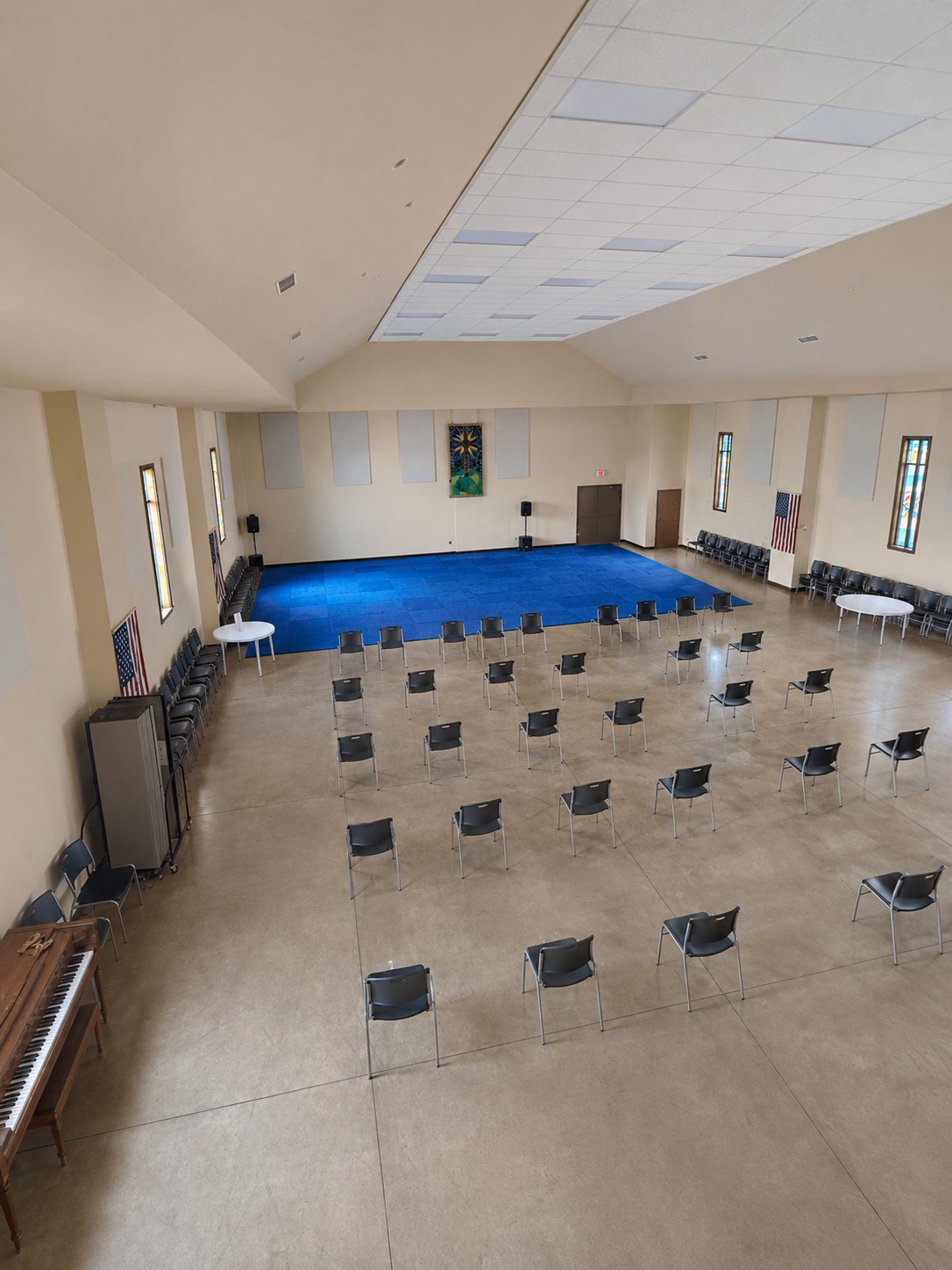 Large Fellowship Hall set with rows of chairs facing the platform