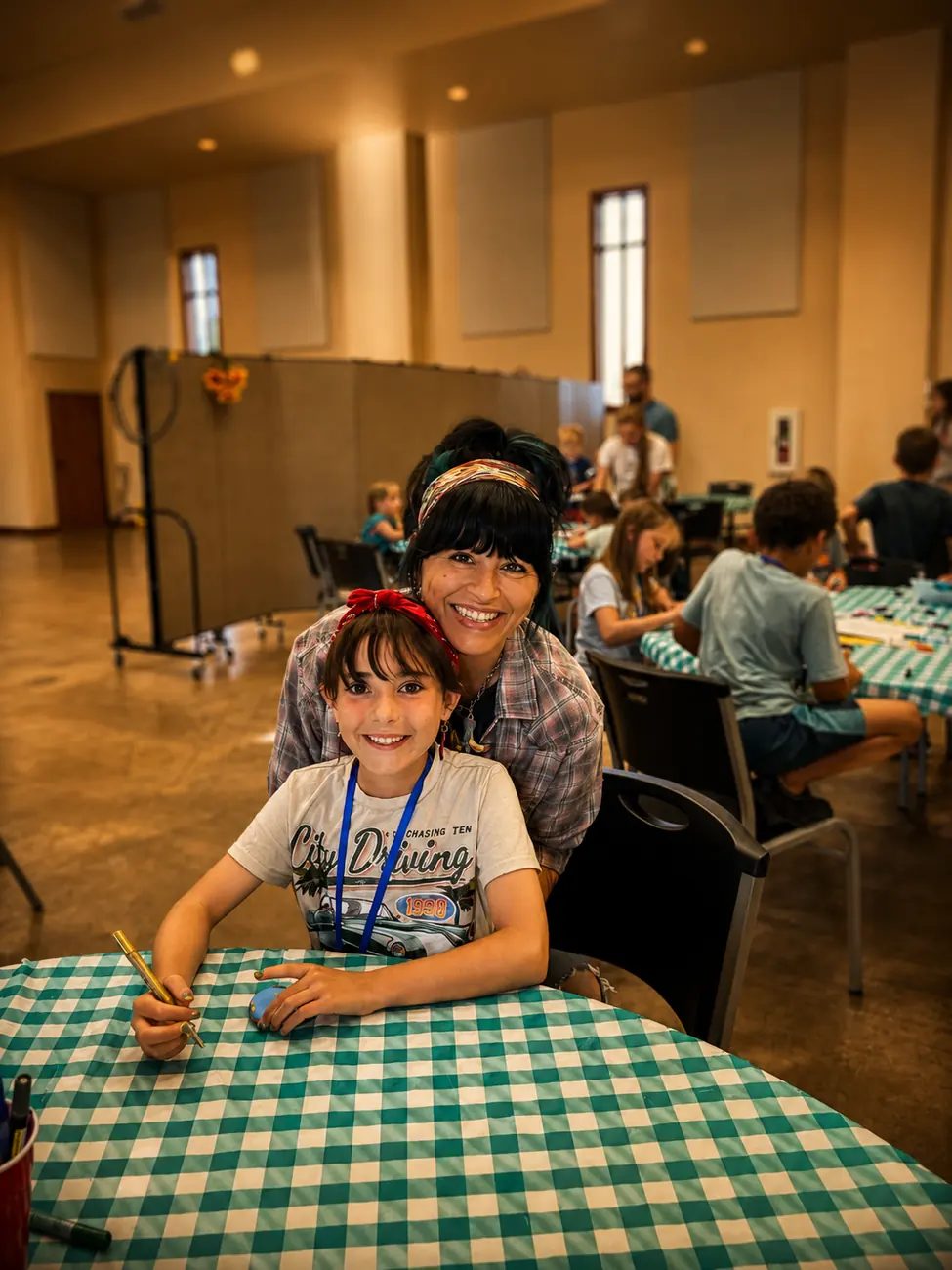 A child and adult participating together in a church activity
