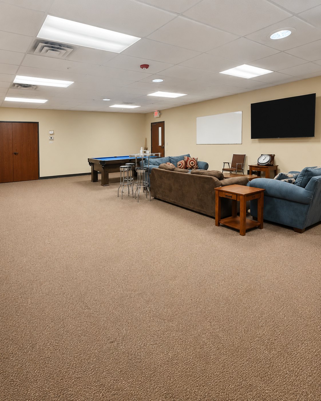 Youth room with couches, pool table, and television