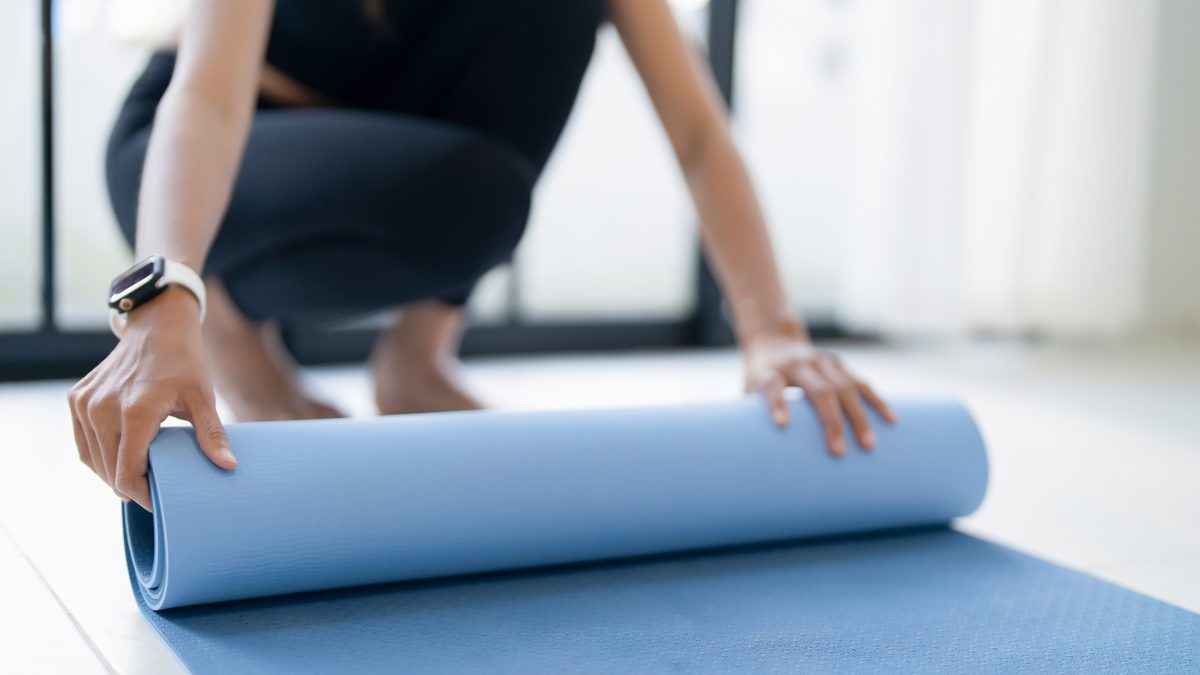 Rolling out a yoga mat